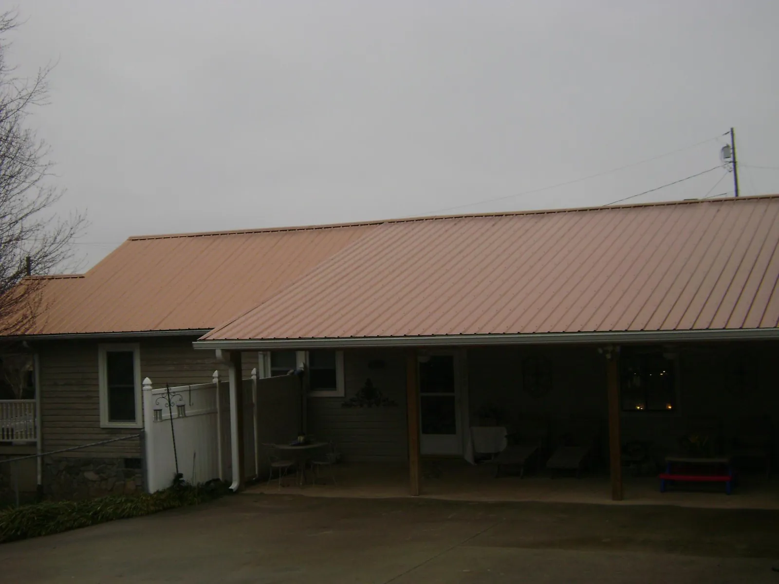 Copper toned metal roof over a wide covered patio in New Iberia
